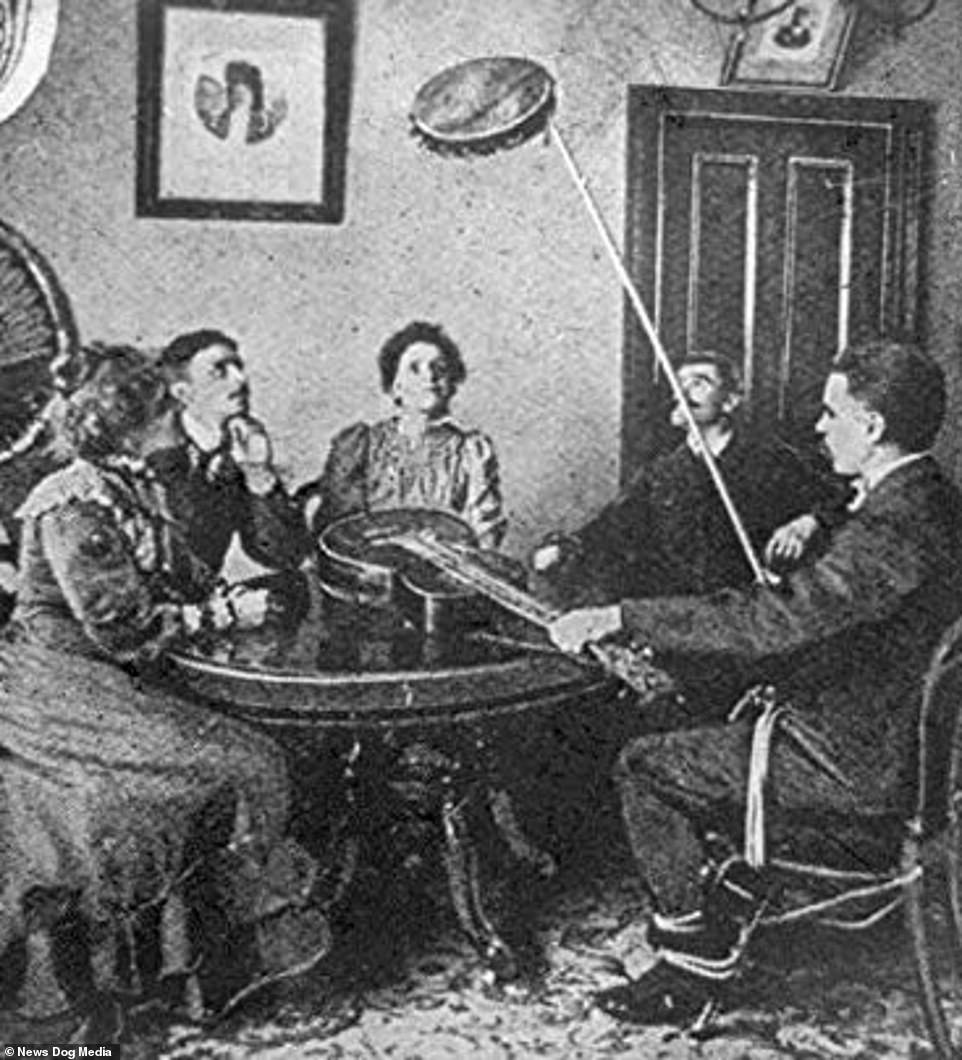 7786520-6526713-A_seance_with_five_people_around_table_four_of_them_looking_upwa-m-53_1545649878586